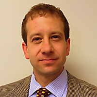transitioning: Jonathan F. Zaff (headshot), director of the CERES Institute for Children and Youth, short dark hair, tweed jacket, striped shirt, polka dot tie