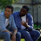 transitioning: Black teenager male ignoring scolding adult sitting on bench