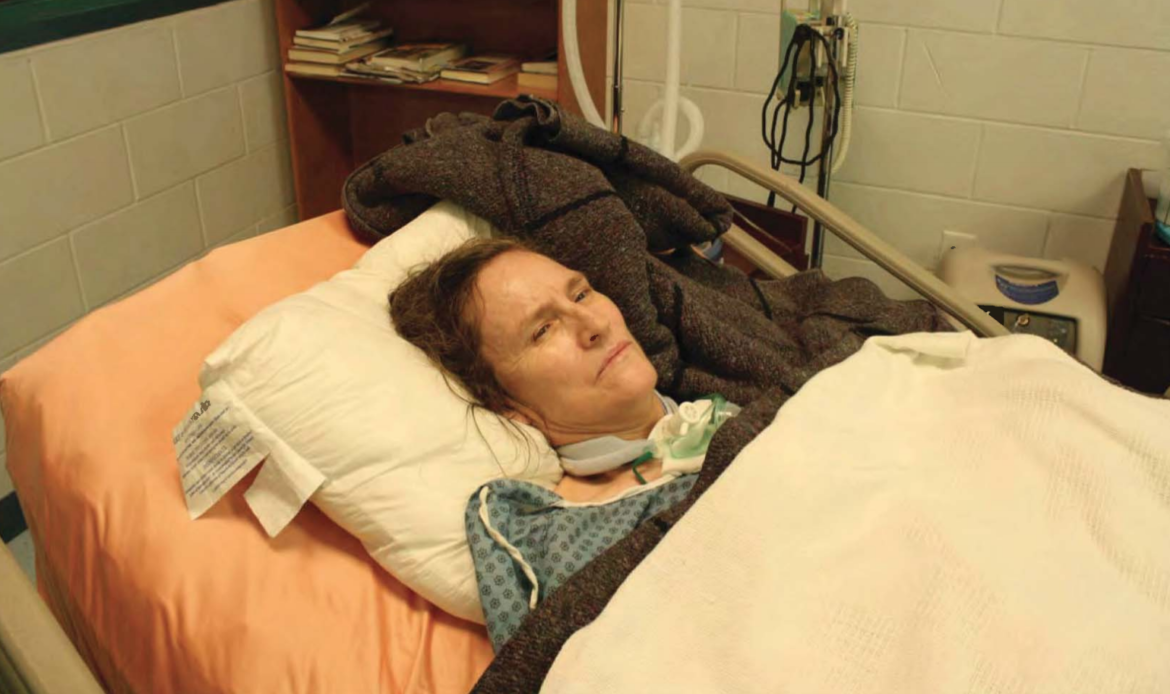 conditional medical release: Woman is propped up in hospital bed with orange sheets.