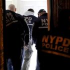 gang database: Rear view of men wearing coats with NYPD Police on it