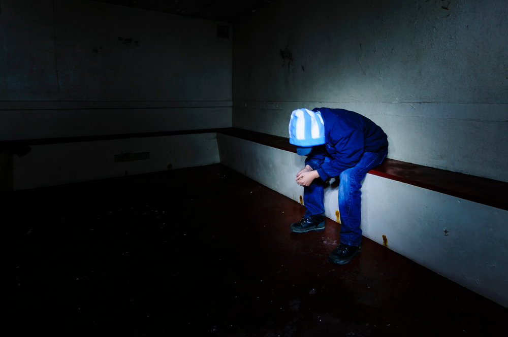 tag: youth in hoodie sits in prison cell, head bowed
