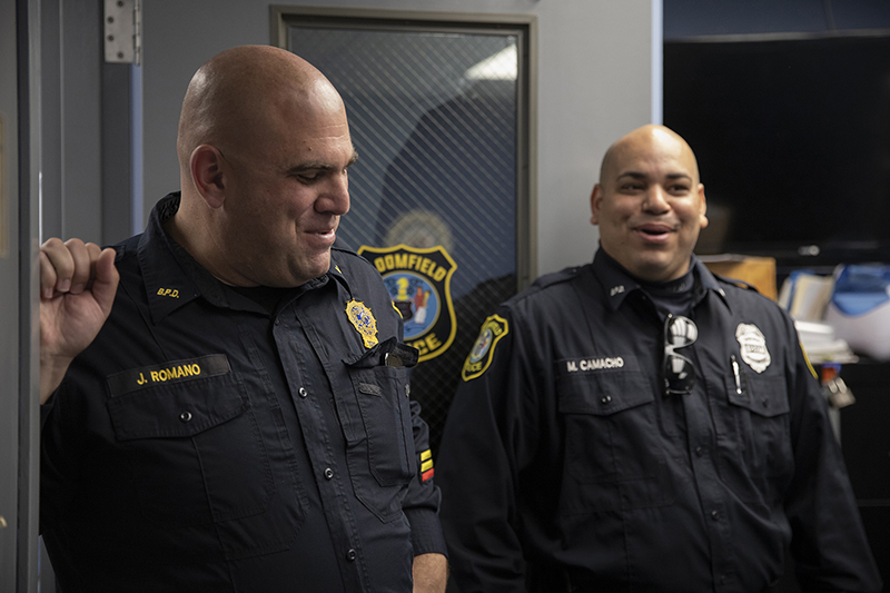 Bloomfield: 2 smiling men in police uniform.