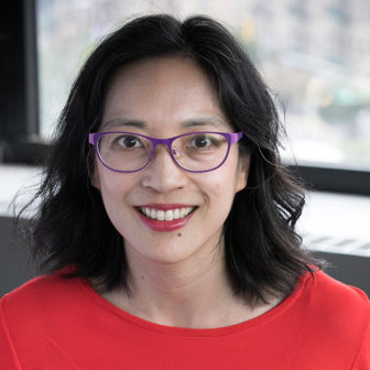 LFOs: Leslie Paik (headshot), associate professor of sociology at The City College, smiling woman with dark hair, pink glasses, orange top
