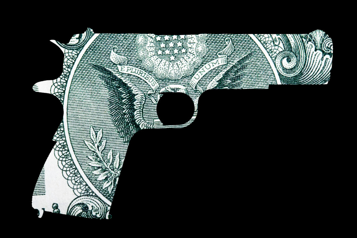 VOCA: Shape of Gun over detail of U.S. Dollar Bill, money