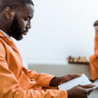 Florida: side view of african american prisoner reading book