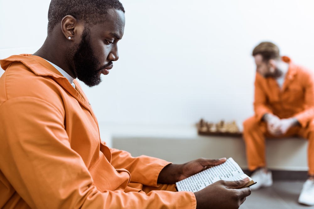 Florida: side view of african american prisoner reading book