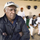 recidivism: Senior team coach looking away with people in the background
