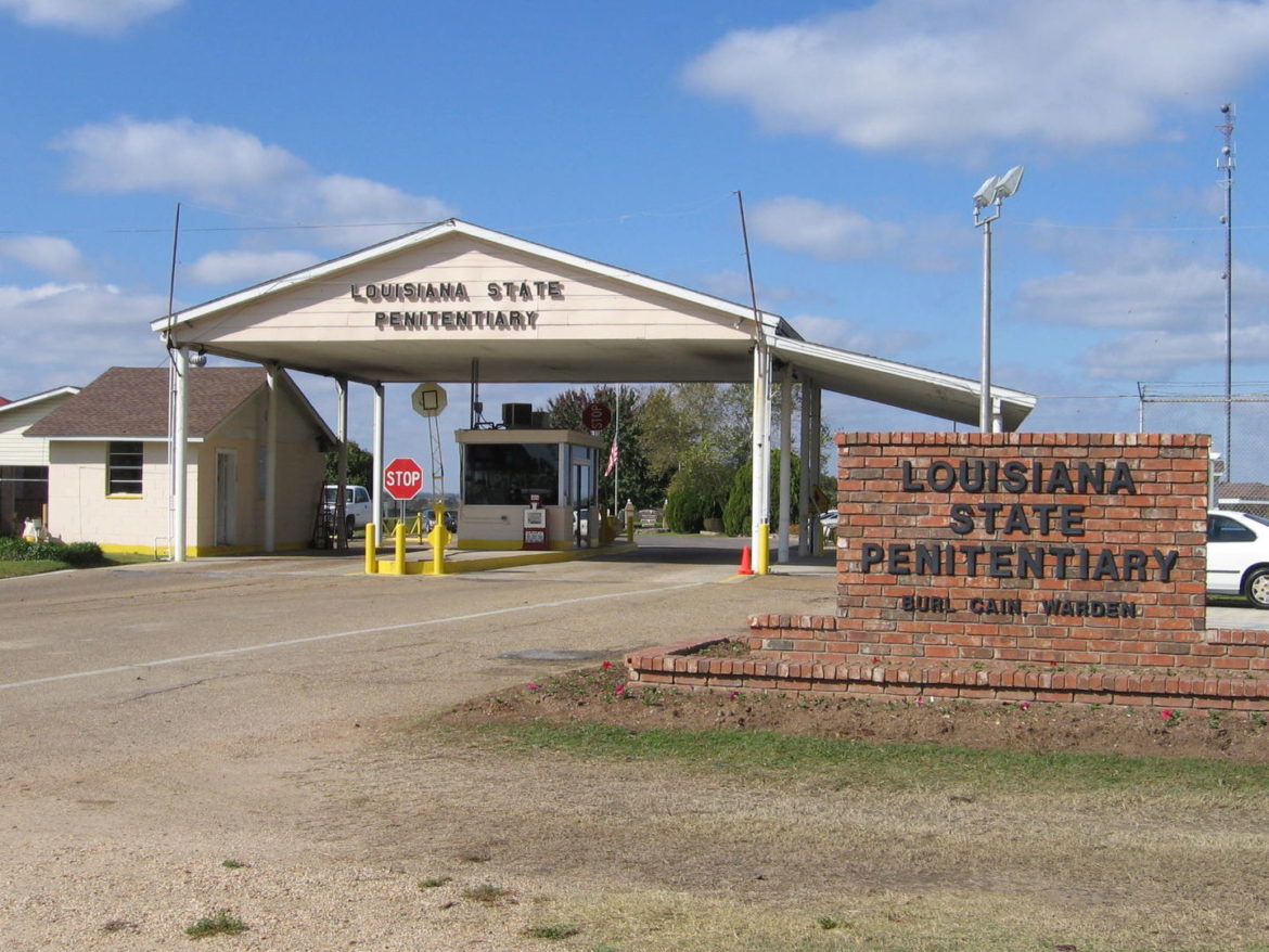Angola: The entrance to the Louisiana State Penitentiary - The placard says "Louisiana State Penitentiary" and "Warden Burl Cain"