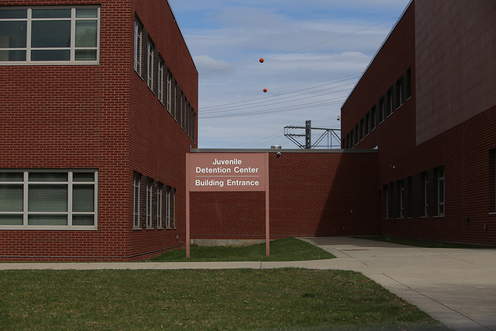 Connecticut: Outside of brick building with sign saying Juvenile Detention Center Building Entrance