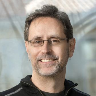 fees and fines: Jeffrey Selbin (headshot), director of the Policy Advocacy Clinic at the University of California at Berkeley School of Law, man smiling with glasses, earrings and black sweater