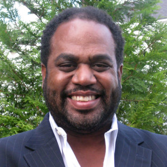 gun violence: Joseph B. Richardson, Jr. (headshot), professor of African-American studies and anthropology at the University of Maryland, College Park, smiling man outdoors with white dress shirt, black vest