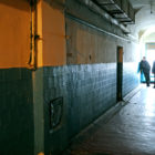 California: View of prison hallway, prison guards standing at the far end