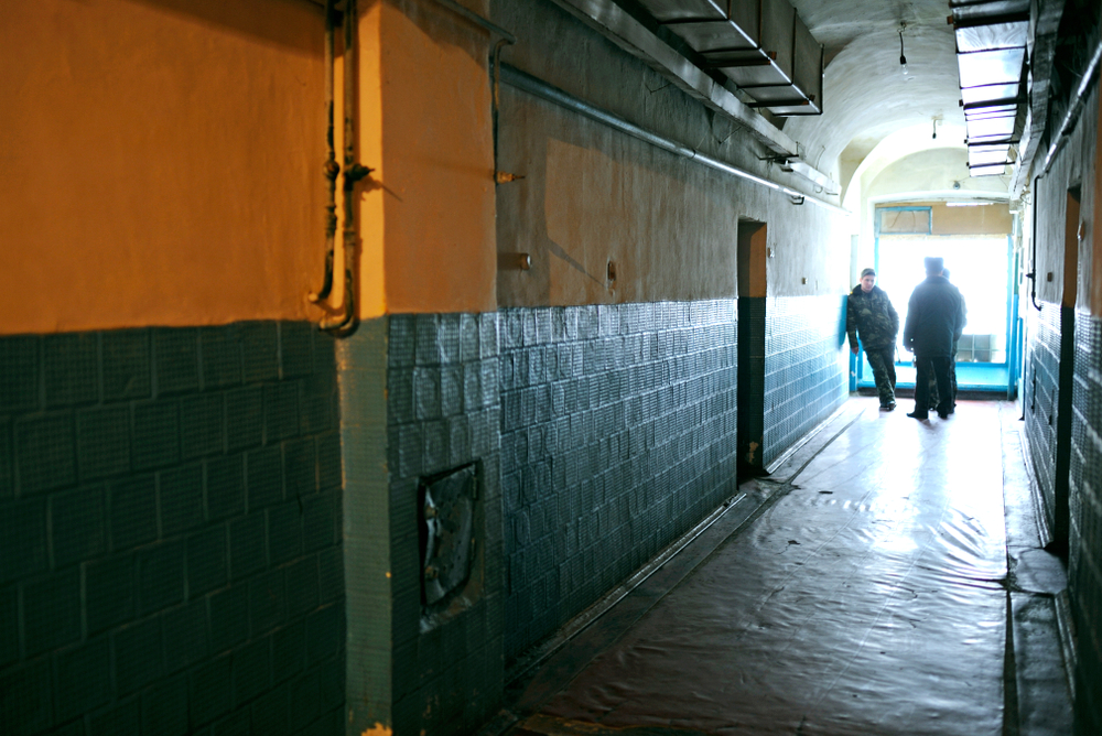 California: View of prison hallway, prison guards standing at the far end