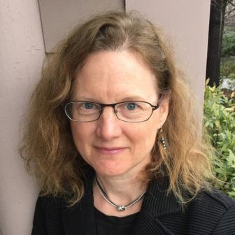 emerging adults: Lael E.H. Chester (headshot), director of Emerging Adult Justice Project, woman with light brown hair, glasses, earrings, necklace in black top