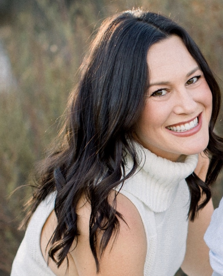 philanthropy: Ally Barron (headshot), development and communications officer of Hope and Heal Fund, smiling woman with long dark hair wearing sleeveless white turtleneck