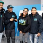 SAVE: 4 men, 1 woman, all smiling, pose in group, all wearing matching sweatshirts that say save east harlem