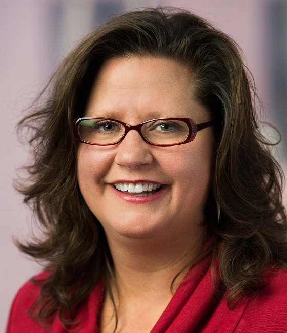 engagement: Janine Zweig (headshot), associate vice president of justice policy at Urban Institute, smiling woman with brown shoulder-length hair, glasses, red cowl-neck top