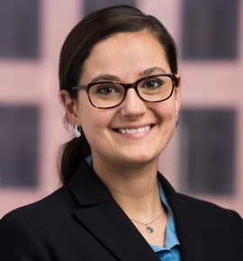 engagement: Leah Sakala (headshot), senior policy associate at Urban Institute Justice Policy Center, smiling woman with brown ponytail, glasses, earrings, black jacket, blue blouse