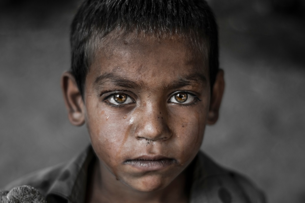 survival mode: Closeup of boy with sad expression on his face