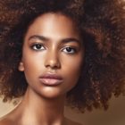 sex trafficking: Closeup of beautiful, serious young black woman with reddish afro