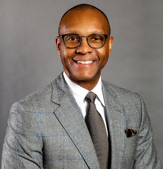 connection: DePriest Waddy (headshot), chief executive officer of Families First, smiling man with short dark hair, gray suit, tie, white shirt.