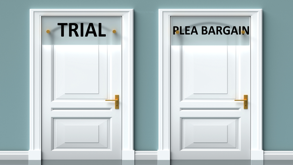 plea bargain: Trial and plea bargain as a choice - pictured as words on 2 doors