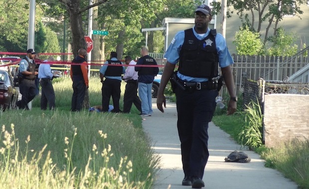 Police in Chicago, where homicides have soared recently, as they investigated a fatal shooting in May 2014 of a man in the 5700 block of South LaSalle Street.