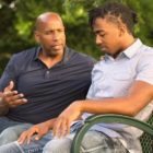 New York aims to narrow gap between minority vs white juvies sent to community programs: man mentors young african american man on park bench