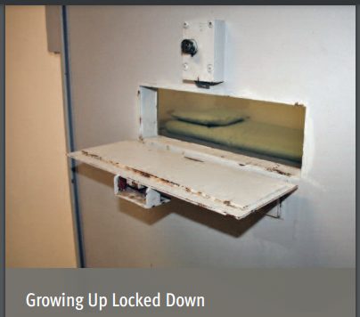 ACLU report cover : food slot in isolation cell door