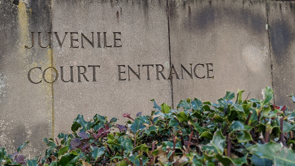 JJIE Hub Latest Resources::Weathered Stone Slabs With the Words "Juvenile Court Entrance" Engraved