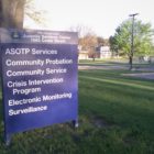 Community probation, community service, crisis intervention and other services are listed on a sign outside a juvenile probation office.