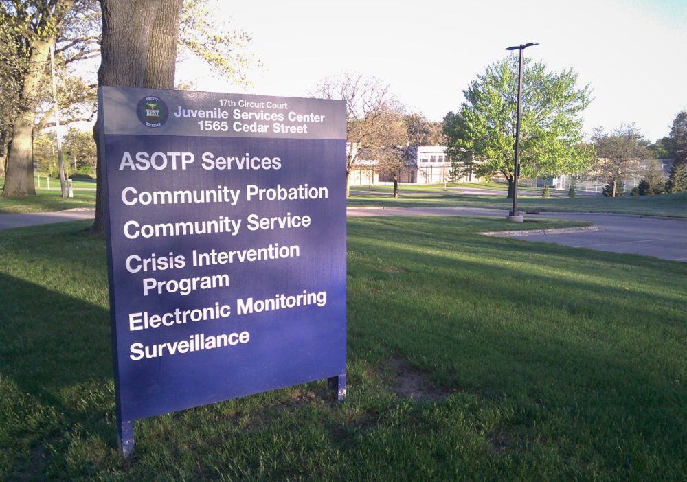 Community probation, community service, crisis intervention and other services are listed on a sign outside a juvenile probation office.