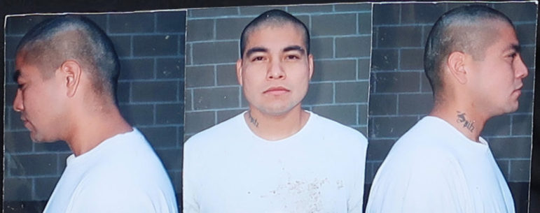 Juvenile lifers: Three mug shots - one full face and two profiles - of same adult man with short dark hair in front of red brick wall.