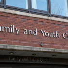 Teen court: Red brick building with closeup of sign in silver letters reading "Family and Youth Court""