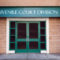 Juvenile court division entry with sign above white-framed, green double doors in red brick building