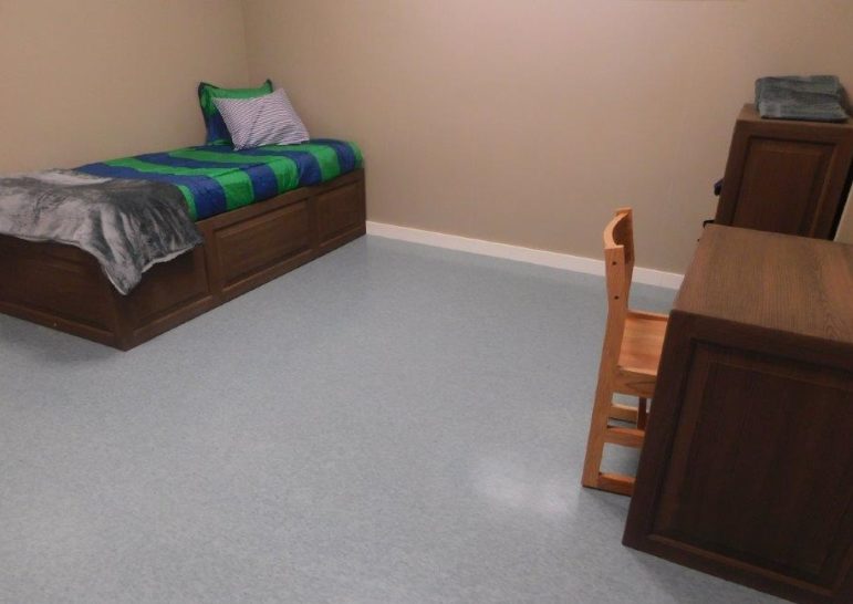 Connecticut turnaround of juvenile system sets standard: room with bed, desk and dresser