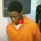 Teen Murder Sentence: Black teemn in orange prison jumpsuit with head down stands next to white cop in black uniform following