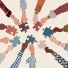 Alternatives to prison: Group of multicultural arms an hands forming circle reaching to each other with multi-colored puzzle pieces