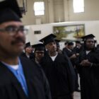Free college for more prisoners: group of men in graduation garb looking off to the right