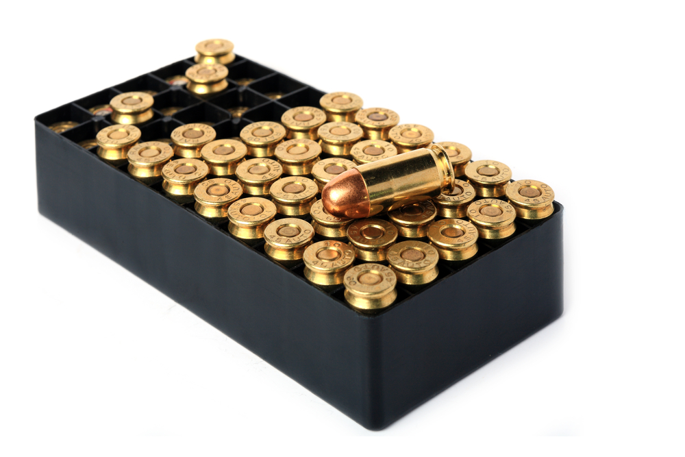 Gun Safety at Home; Almost 40 brass tipped bullets packed tightly in an open black box
