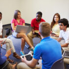 Restorative justice: Several high school students sit in a circle of chairs having a discussion