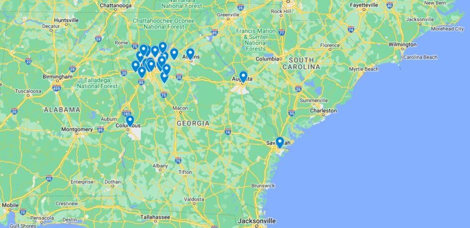 Georgia school violence map: Map of Georgia, US, and some surrounding east coast area in greens and yellows, next to light blue Atlantic Ocean, with darker blue map pins on locations of school violence incidents