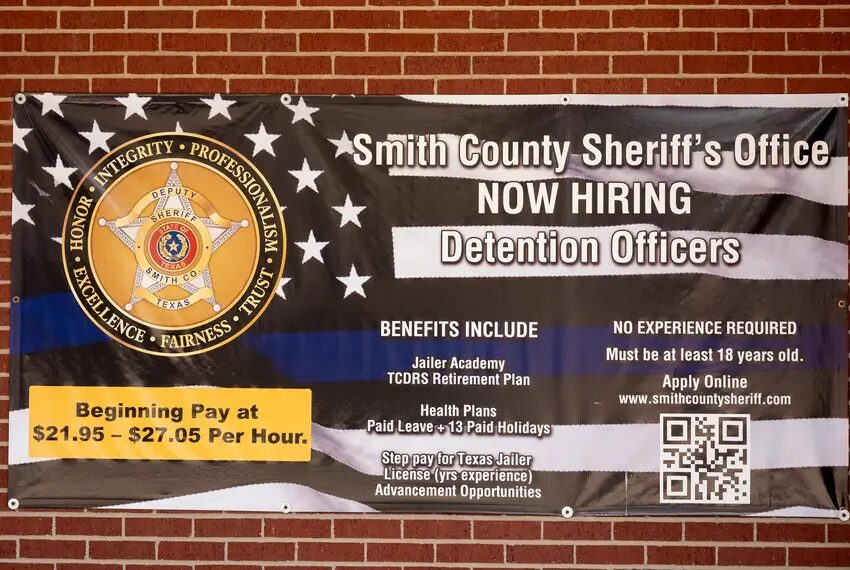 Teens as Texas Jail Guards: Display poster for prison guard jobs hung on red brick wall