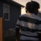 11-year old arrested for making threat in Tennessee: view of young black child form behind in horizontal striped shirt at dusk