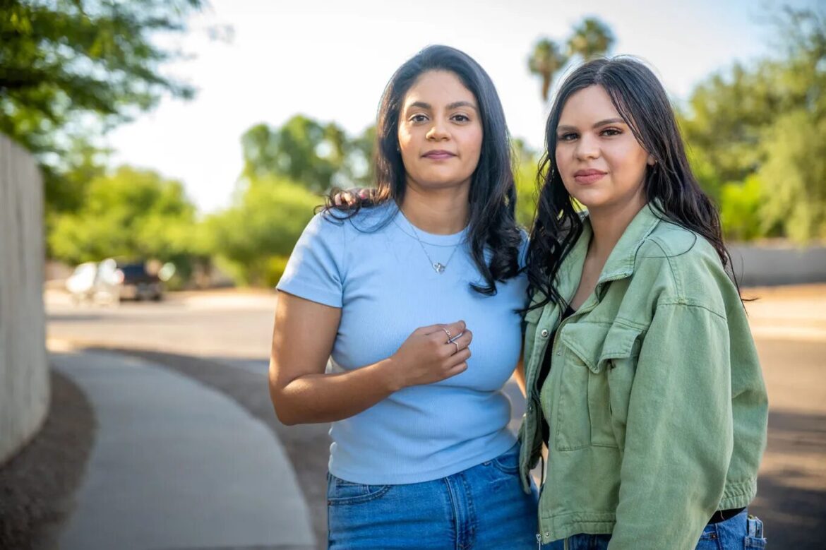 Latino voters gun reform Arizona: Two women with long dark hair stand next to each other with empty street and trees in background