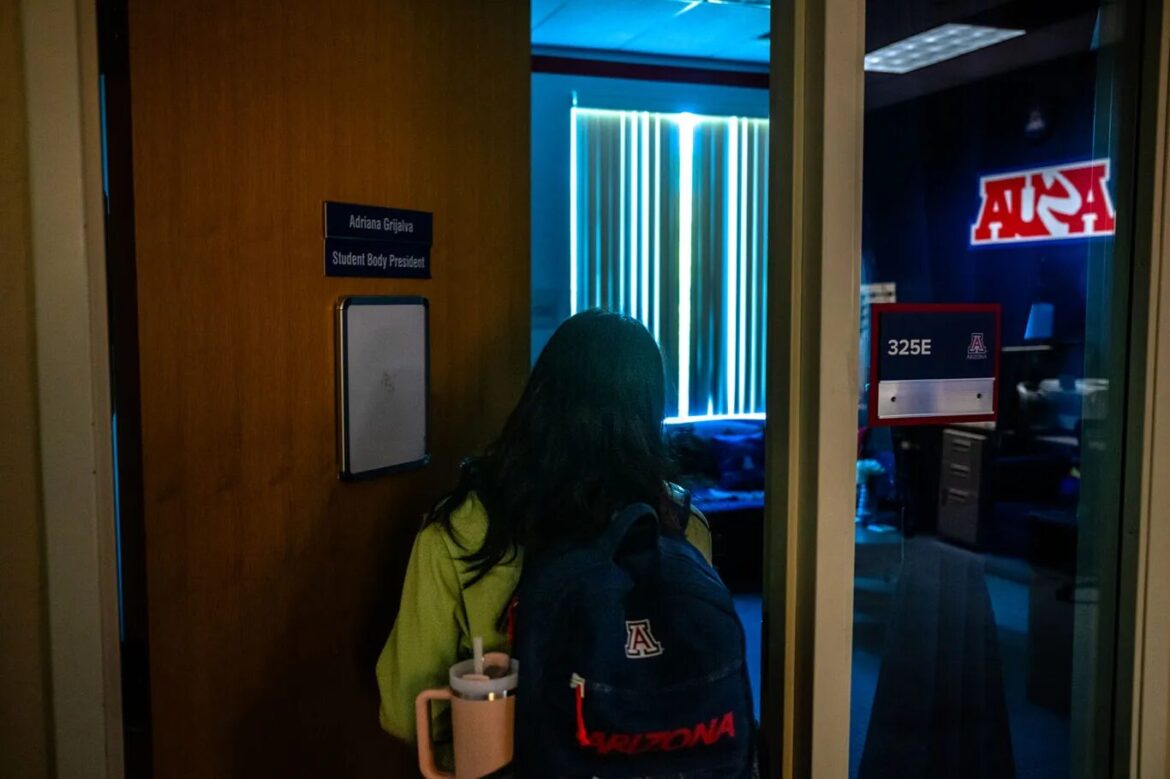 Latino voters gun reform Arizona: Woman with long dark hair walks into office through light wood door